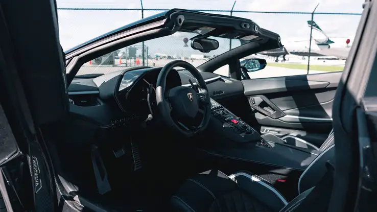 Black Lamborghini Aventador S Roadster rental dashboard view mph club