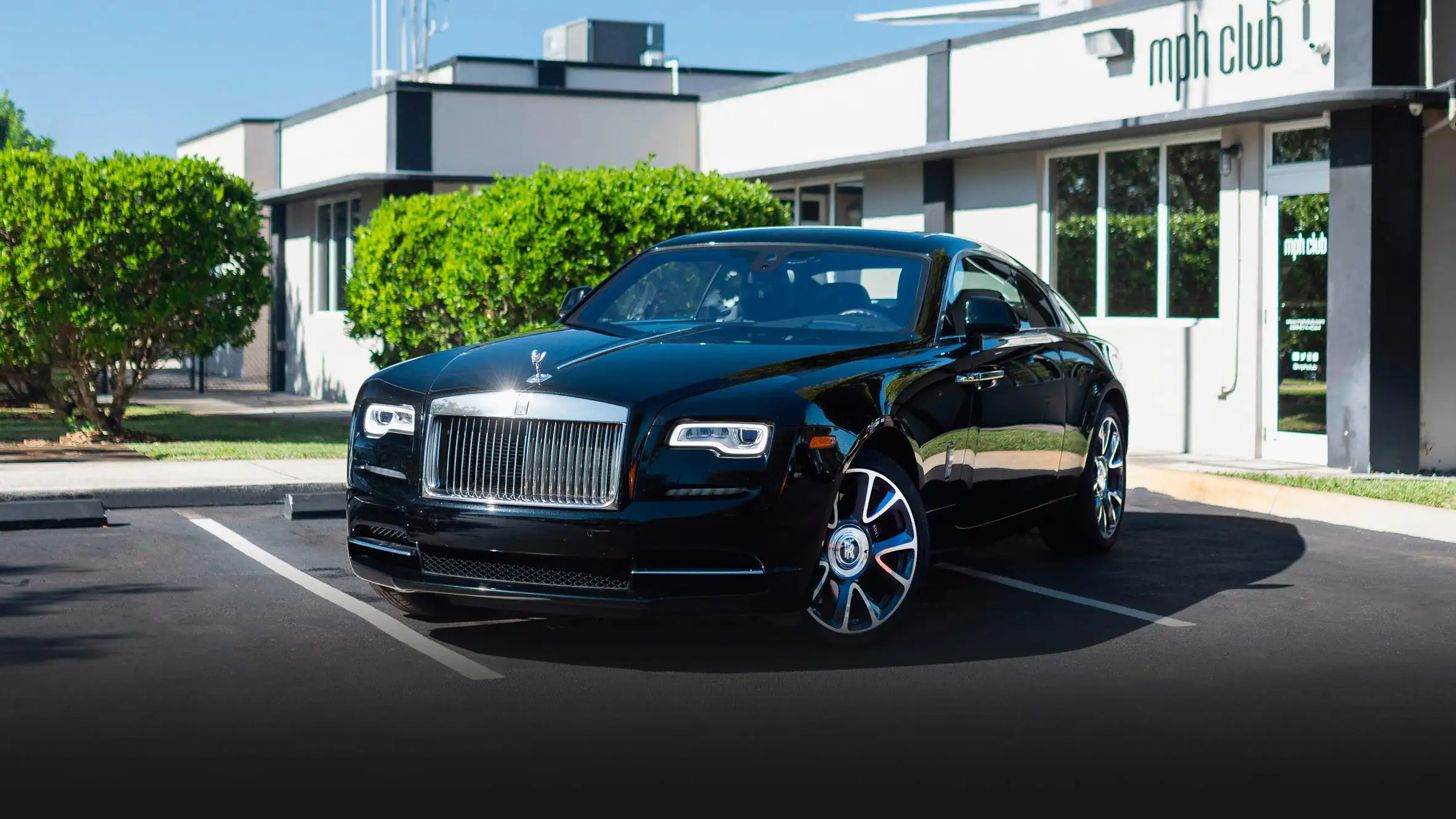 Black on black Rolls Royce Wraith rental Miami profile view mph club