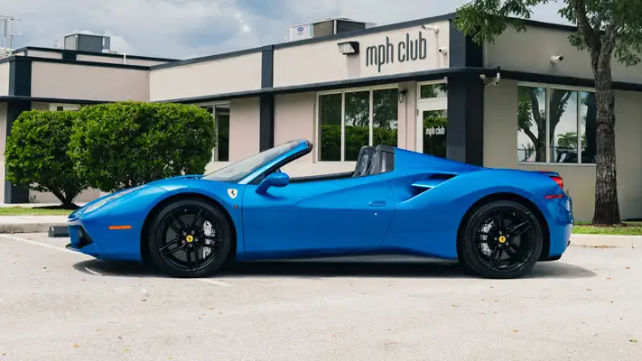 Blue Ferrari 488 Spider rental side view mph club