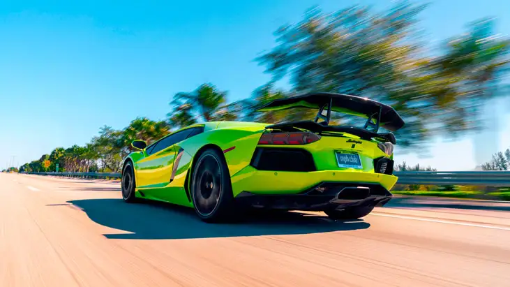 Green Lamborghini Aventador rental rear view mph club