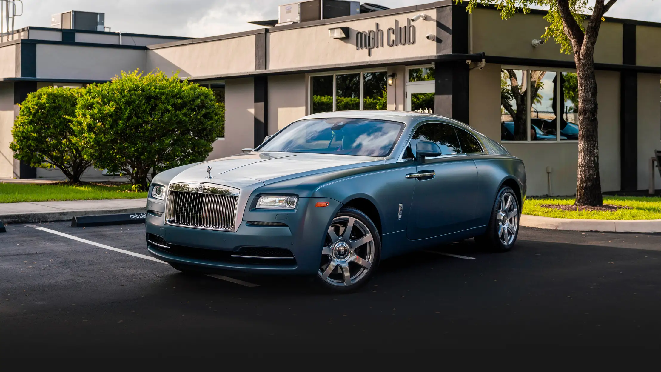 Matte blue Rolls Royce Wraith rental profile view mph club