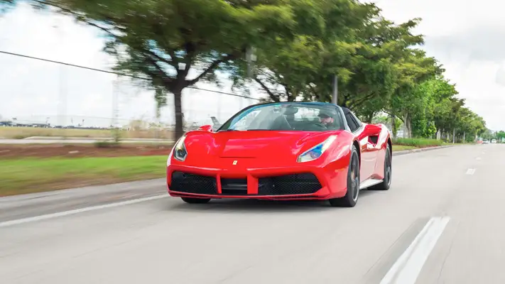 Red on black Ferrari 488 Spider for rent miami rolling view - mph club