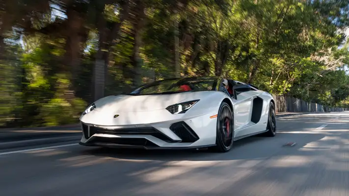 White Lamborghini Aventador S Roadster for rent Miami rolling view mph club