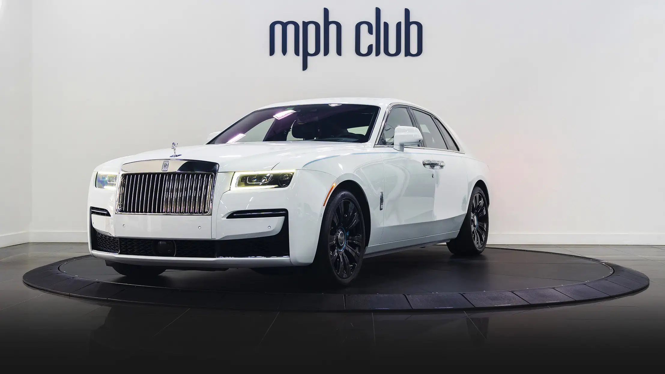 White on blue Rolls Royce Ghost profile view rental mph club
