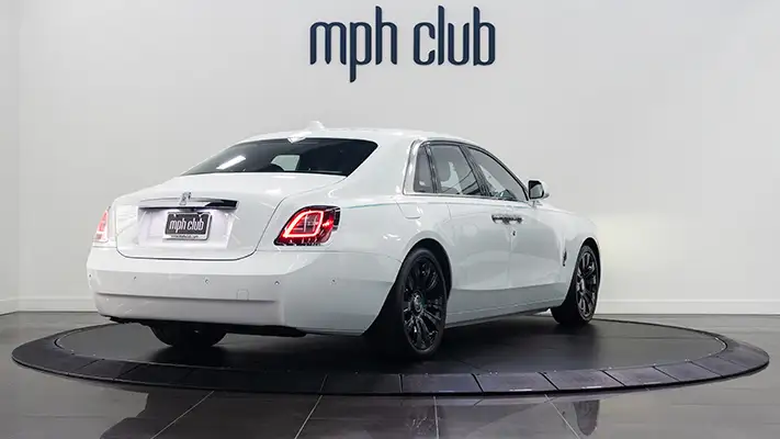 White on blue Rolls Royce Ghost rear view rental mph club