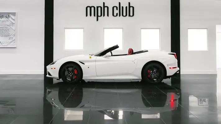 White on red Ferrari California T rental side view mph club