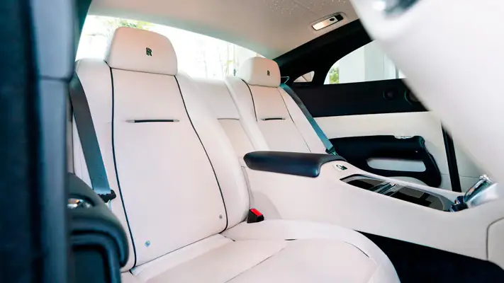 White with white interior Rolls Royce Wraith rental back seats view mph club