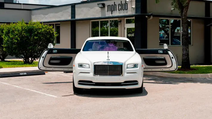 White with white interior Rolls Royce Wraith rental front view mph club