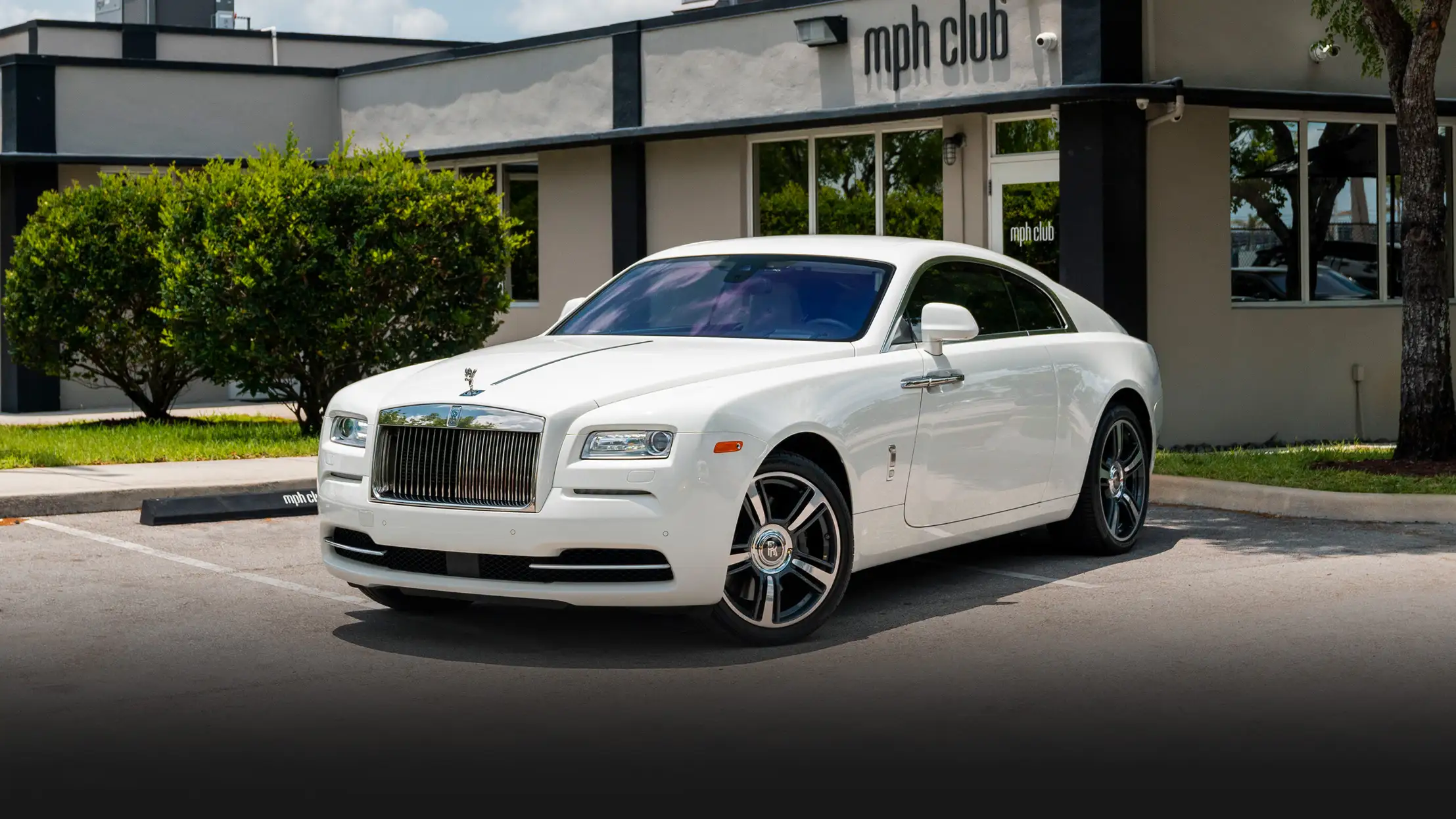 White with white interior Rolls Royce Wraith rental profile view mph club