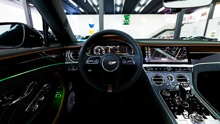 Green Bentley Continental GTC Speed rental dashboard view mph club