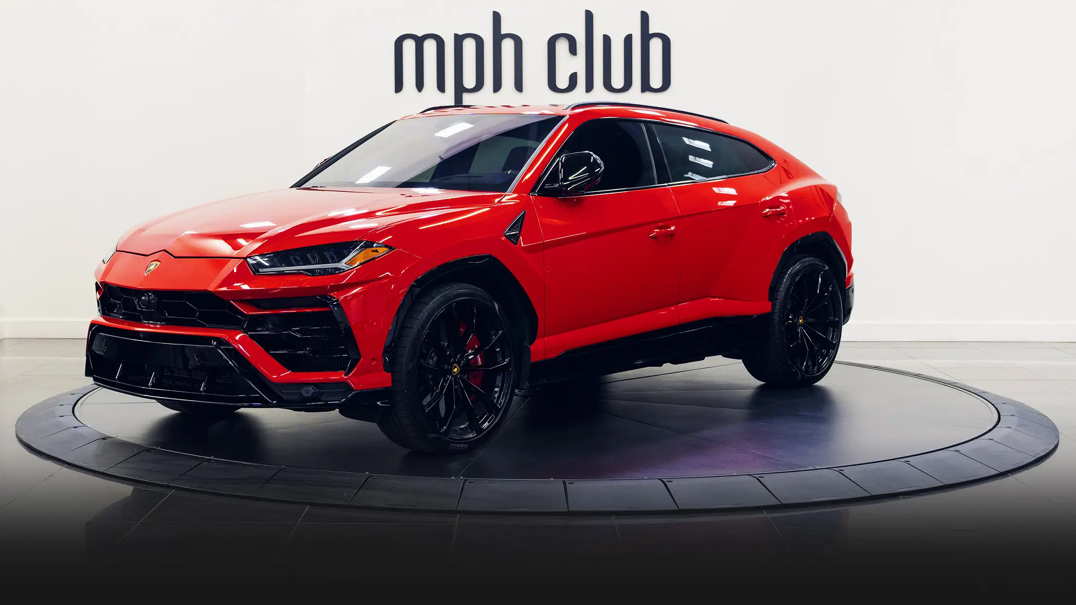 Red on black Lamborghini Urus rental profile view mph club