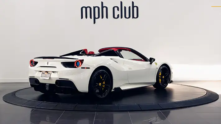 White on red Ferrari 488 Spider for rent rear view mph club