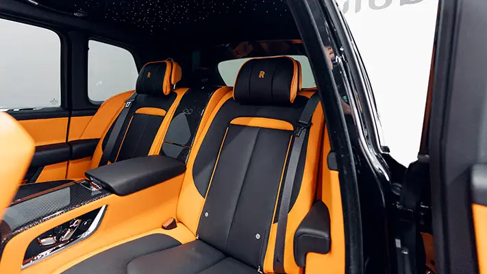 Black on orange 4 seater Rolls Royce Cullinan Black Badge rental interior view turntable mph club