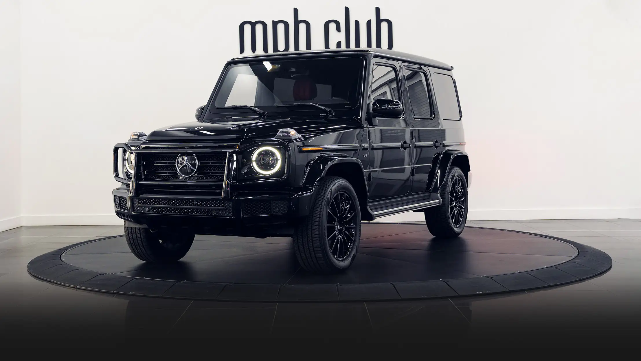 Black on red Mercedes Benz G550 rental profile view turntable mph club