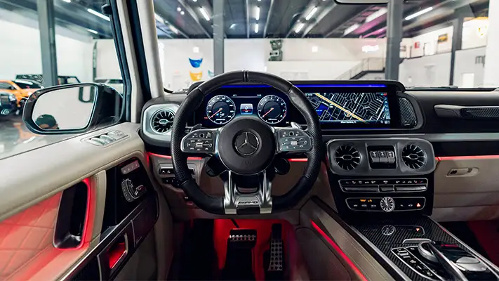 Sand with white interior Mercedes Benz G63 AMG G Wagon rental dashboard view turntable mph club