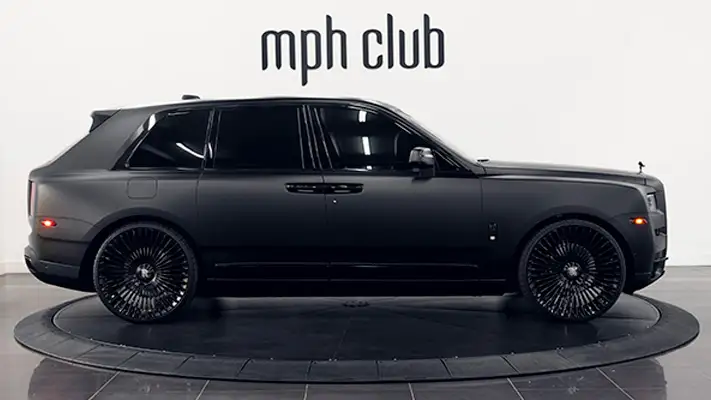 Matte black Rolls Royce Cullinan rental side view mph club