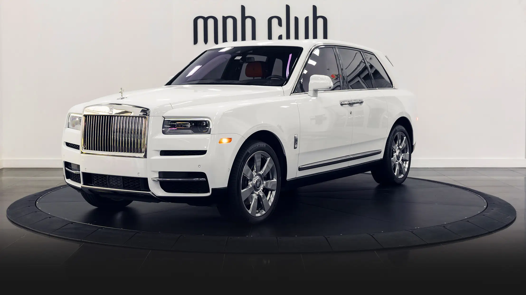 White exterior with orange interior Rolls Royce Cullinan rental profile view mph club