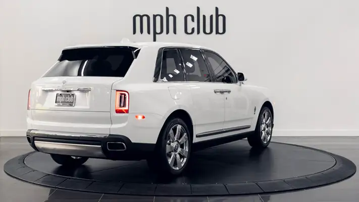 White exterior with orange interior Rolls Royce Cullinan rental rear view mph club