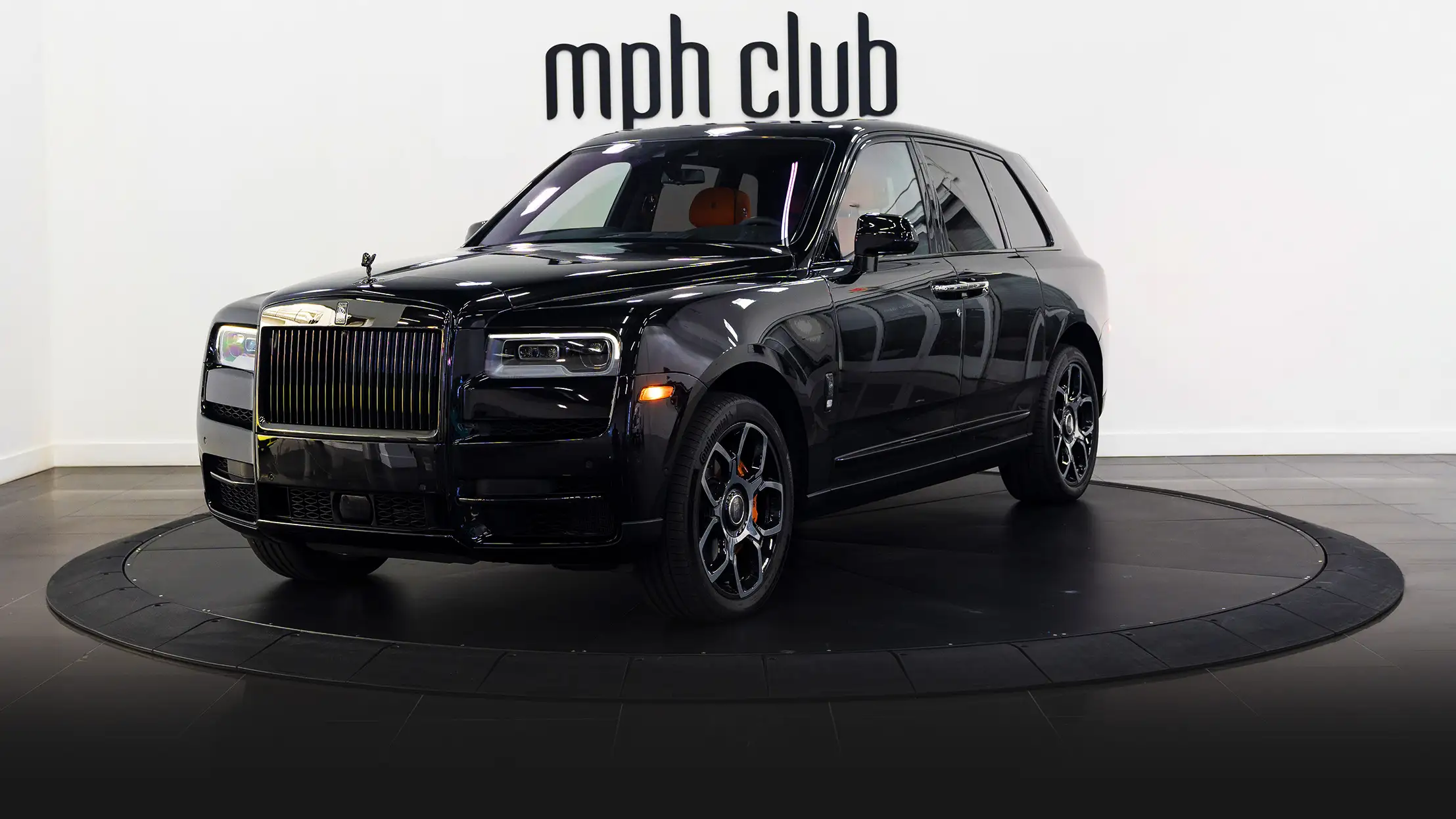 Black on orange Rolls Royce Cullinan black badge rental profile view mph club