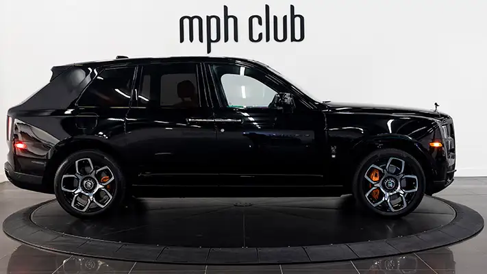 Black on orange Rolls Royce Cullinan black badge rental side view mph club