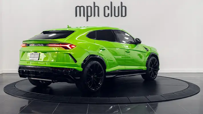 Green Lamborghini Urus rental rear view mph club