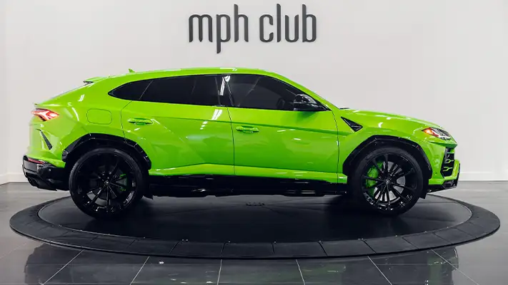 Green Lamborghini Urus rental side view mph club