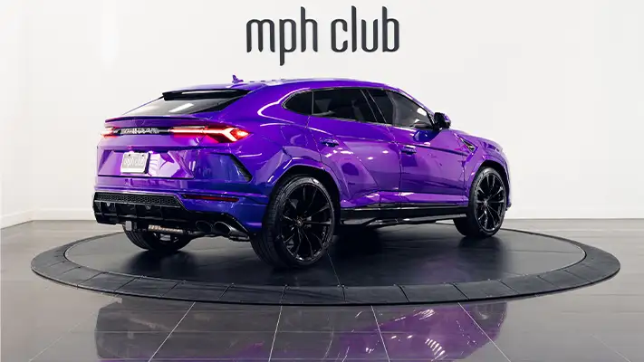 Purple Lamborghini Urus rental rear view mph club