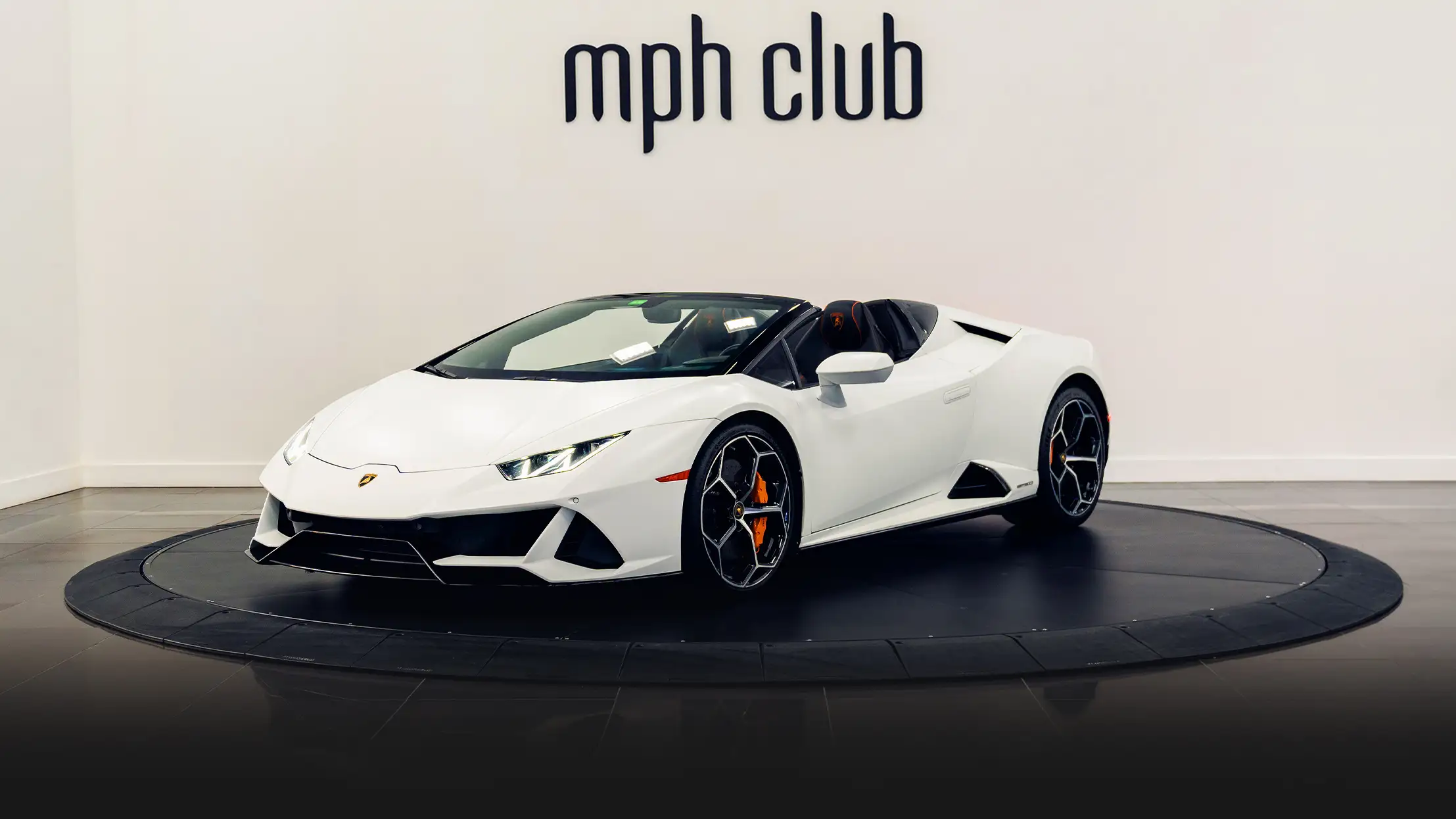 White matte Lamborghini Huracan EVO Spyder rental profile view turntable mph club