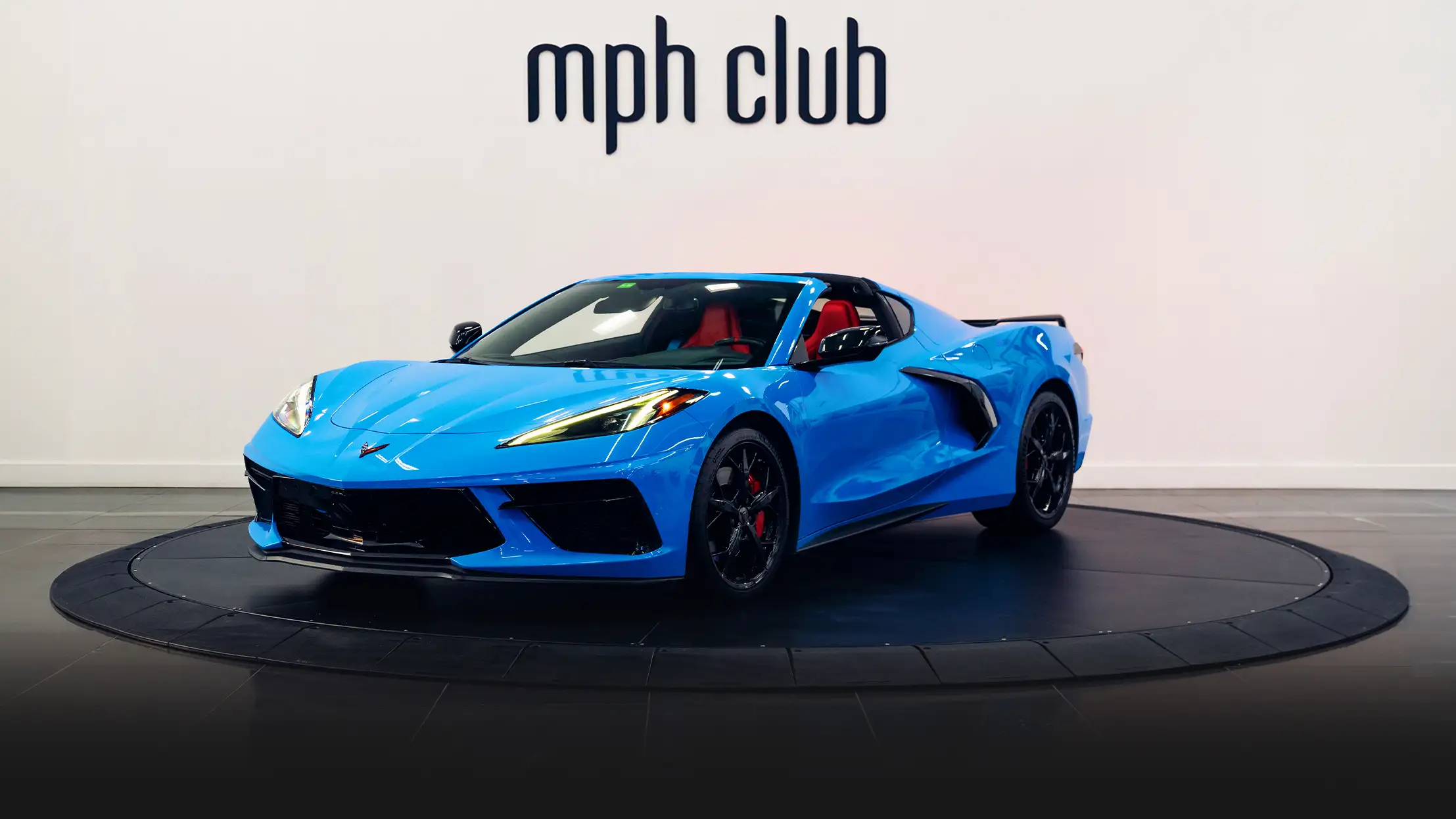 Blue Chevrolet Corvette C8 rental profile view - mph club turntable