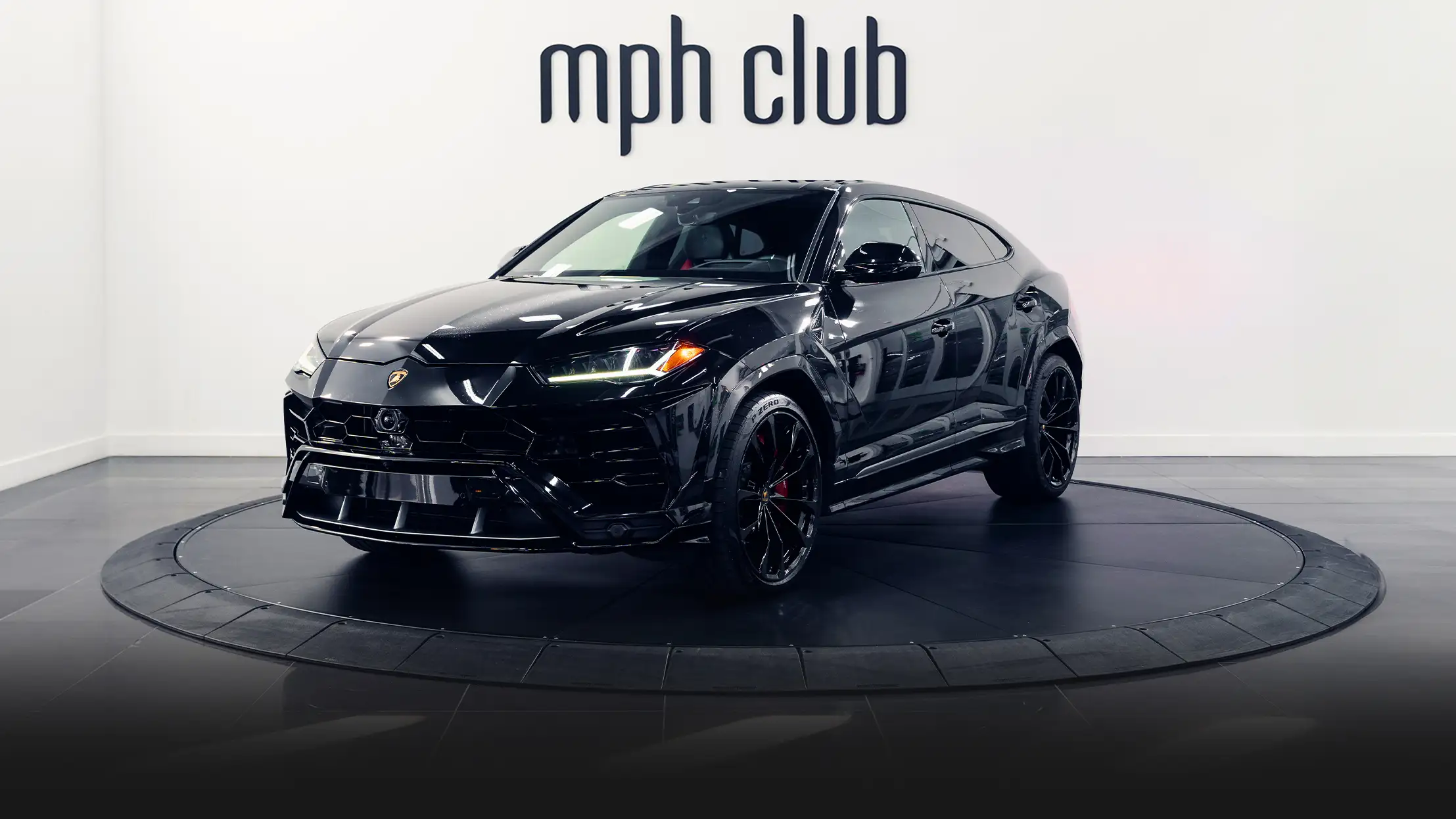 Black on red Lamborghini Urus rental profile view turntable - mph club