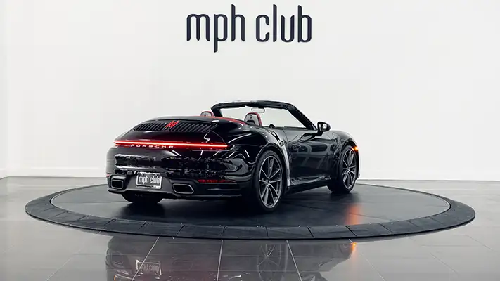Black Porsche 911 Carrera Cabriolet rental rear view - mph club