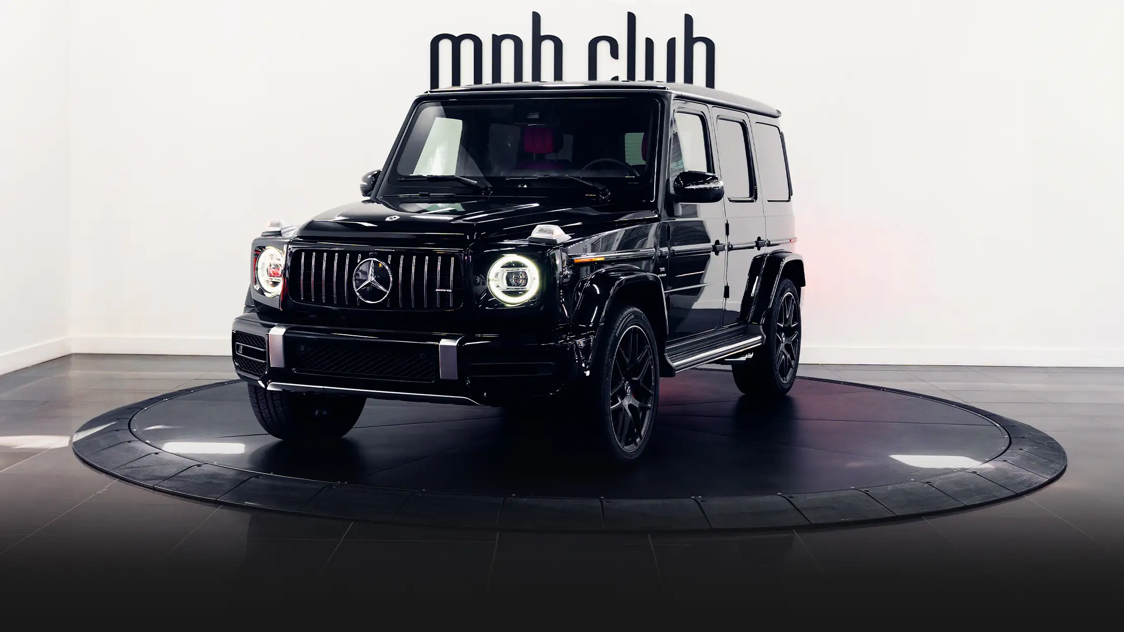 Black with red Mercedes Benz G63 AMG G Wagon rental profile view - mph club