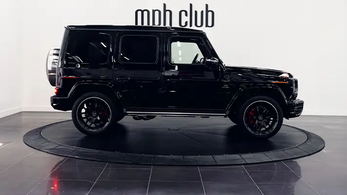 Black with red Mercedes Benz G63 AMG G Wagon rental side view - mph club