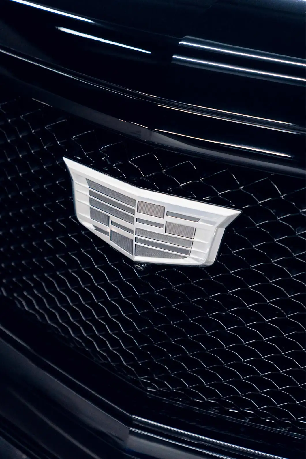 Detail shot of the Platinum Cadillac Escalade logo.
