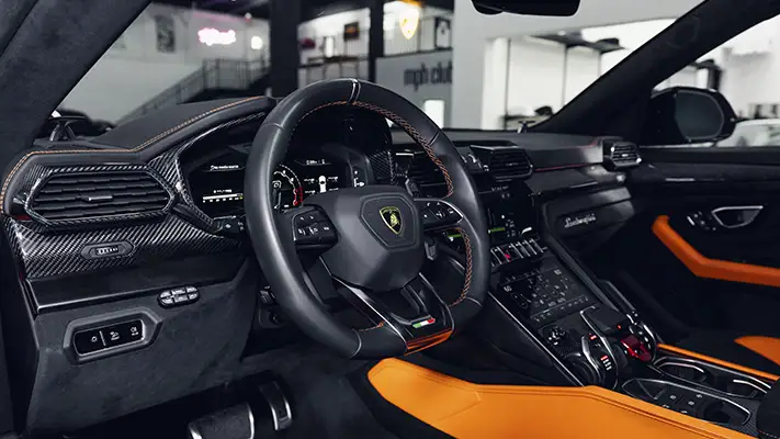 Orange Lamborghini Urus SUV rental dashboard view - mph club