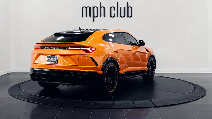 Orange Lamborghini Urus SUV rental rear view - mph club