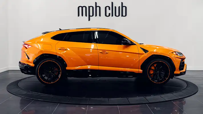 Orange Lamborghini Urus SUV rental side view - mph club