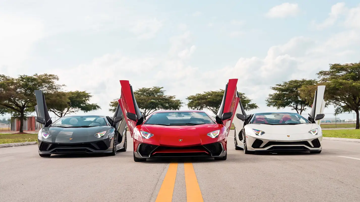 An energy that cannot be replaced: three Aventadors with their butterfly doors up ready to go.