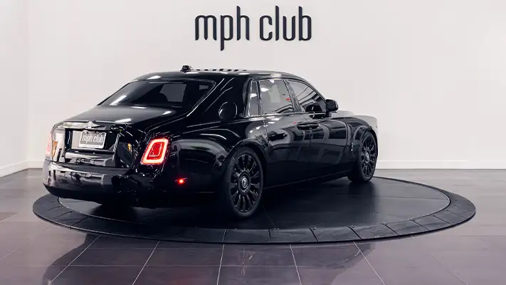 Black on black Rolls Royce Phantom rental rear view - mph club
