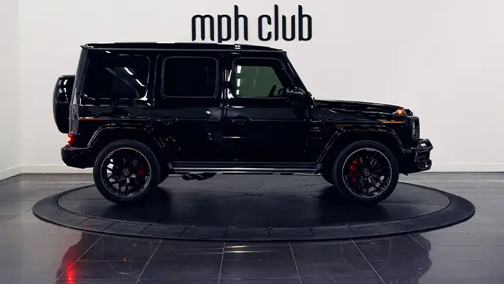 Black on black Mercedes Benz G63 AMG G Wagon rental side view - mph club