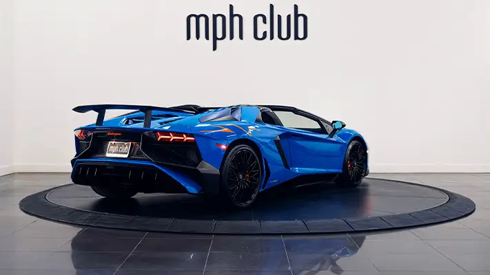 Blue Lamborghini Aventador SV Roadster rental rear view - mph club