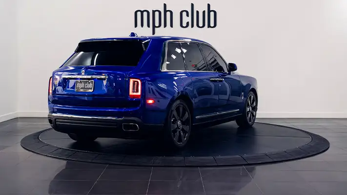 Blue Rolls Royce Cullinan rental rear view - mph club