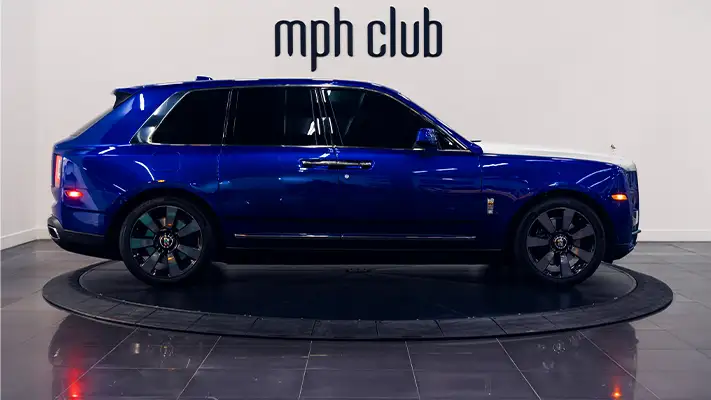 Blue Rolls Royce Cullinan rental side view - mph club