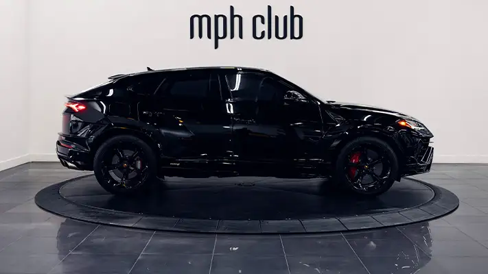 Black on red Lamborghini Urus rental side view - mph club