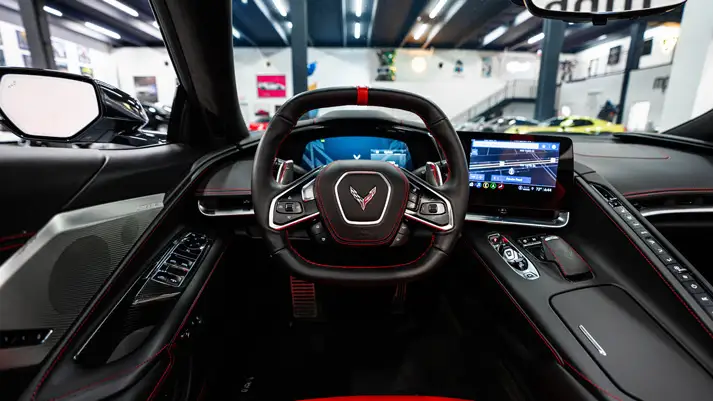 White on red Chevrolet Corvette C8 rental dashboard view - mph club