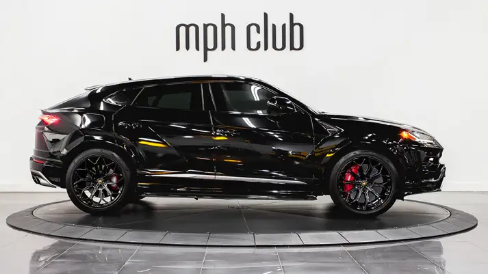 Black on black Lamborghini Urus rental side view - mph club