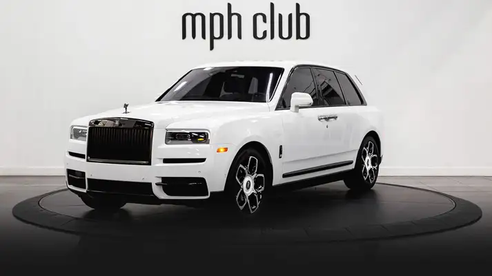 White on blue Rolls Royce Cullinan Black Badge rental profile view rszd - mph club