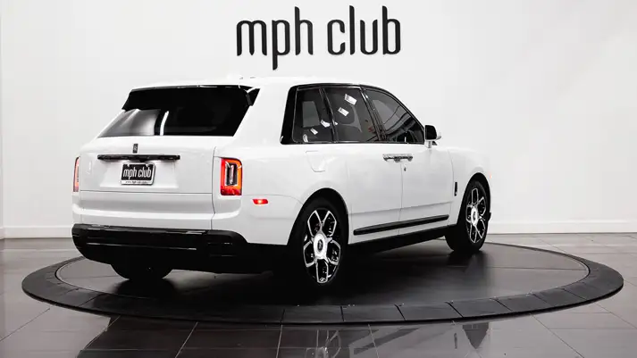 White on blue Rolls Royce Cullinan Black Badge rental rear view - mph club