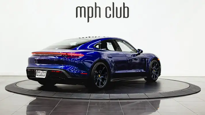 Blue Porsche Taycan rental rear view - mph club