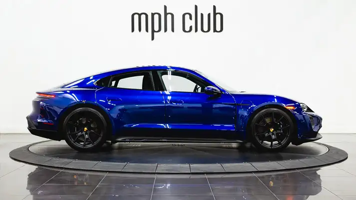 Blue Porsche Taycan rental side view - mph club